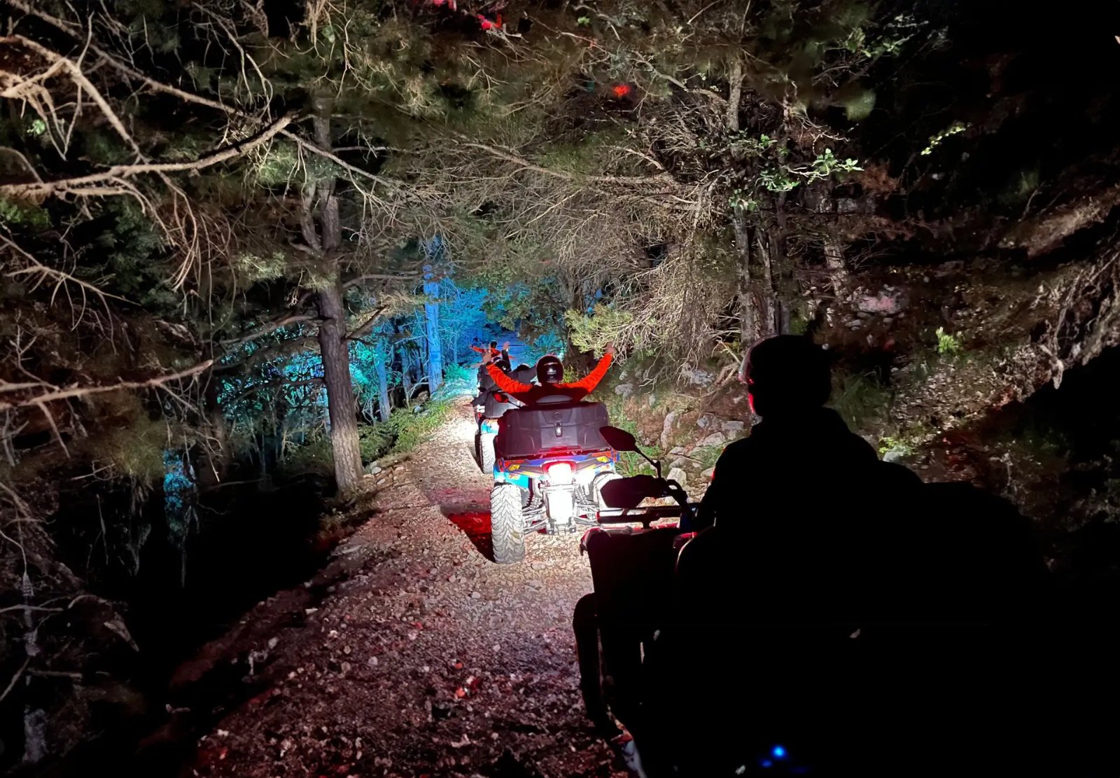 Quad night ride with headlights on a mountain road
