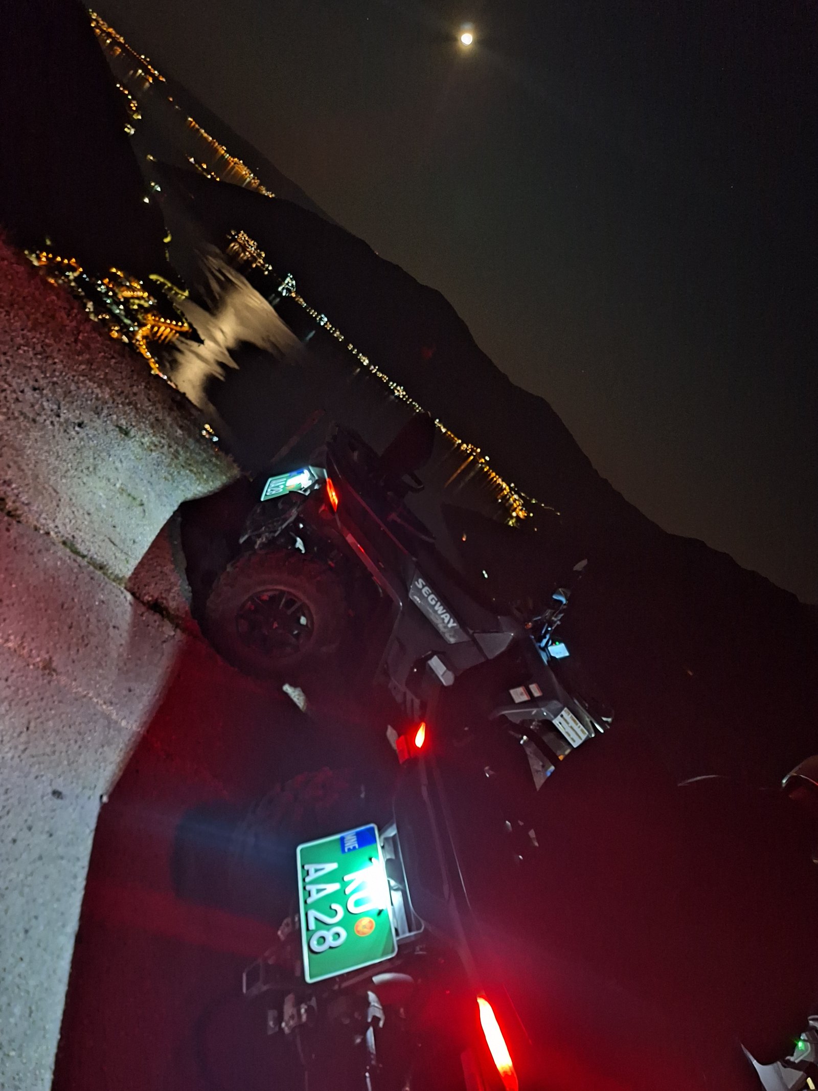 Quad night ride with headlights on a mountain road